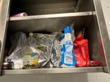 a metal cabinet with a bunch of items inside of it