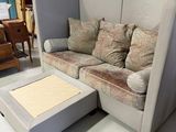 a couch and ottoman in the middle of a room