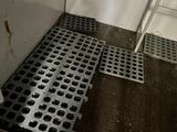 a metal grate on the floor next to a door