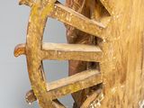 statue of a man on a wheel with a dog on the wheel