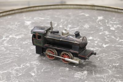 a small toy train on a table with a train track