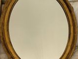un miroir posé sur un lit, à côté d'un oreiller