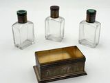 three small glass bottles sitting next to each other on a white surface