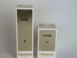 two boxes of perfume sitting next to each other on a white surface