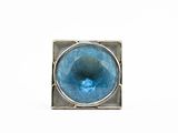 a close up of a ring with a blue stone in it