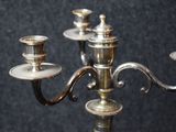 a silver candelab with three candles on it