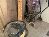 a vacuum and a cart in a room