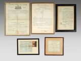 several old documents are hung on a wall in a room