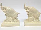 pair of white ceramic fish bookends on a white background