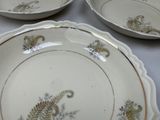 three plates with different designs on them sitting on a table