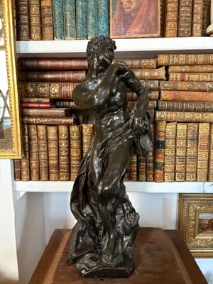 a statue of a woman holding a basket on top of a table