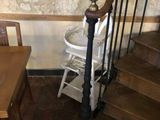 a wooden table and chairs in a room with a stone wall