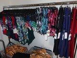 a closet with many different types of clothes hanging on a rack