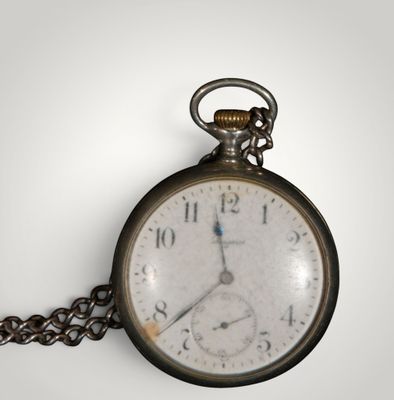 a close up of a pocket watch with a chain around it