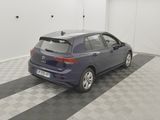 the back end of a blue car parked on a checkered floor