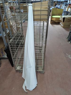 a white cloth hanging on a rack in a warehouse