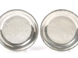 pair of silver plate with beaded rims on a white background