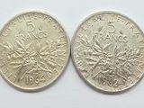 two silver coins are shown side by side on a white surface