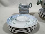 a lot of plates and cups sitting on a table