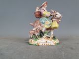 une figurine représentant une femme chevauchant une chèvre