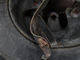 a close up view of a metal helmet with a hole in it