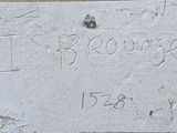 a plaque on the side of a building with writing on it