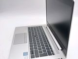 a laptop computer sitting on a white surface