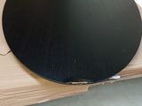 a black round table top on top of a cardboard box