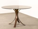 an image of a table with a glass top and metal legs