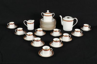 many cups and saucers arranged in a circle on a table