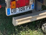 a truck that is parked in the grass with a box on the back of it