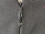an image of a close up of a person ' s sweater with a zipper