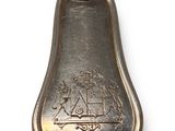 a silver spoon with a handle that has a design on it
