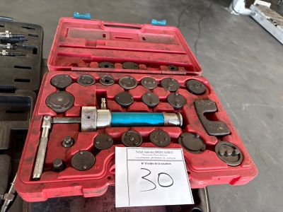 a red case with tools in it sitting on a table