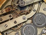 a close up of a pocket watch with gears inside of it