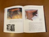 an open book on a table with pictures of furniture and pictures of people