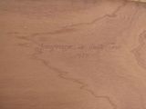 a close up of a piece of wood with writing on it