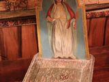 a statue of the virgin mary in a box on a table