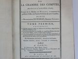 an open book on a white table with a black and white title