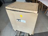 une boîte en carton posée sur un chariot au milieu d'une pièce