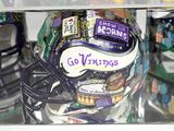a football helmet with a sticker on it in a display case