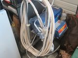a dog that is standing next to a pile of electrical equipment