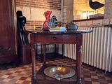 a small table with a bowl on it in a room