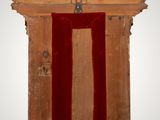 a wooden frame with a red velvet covering on it