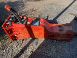 a red machine that is sitting on the ground