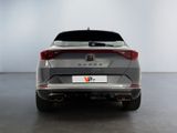 the rear end of a silver car in a white room