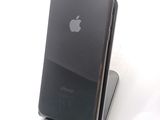 a black iphone that is sitting on top of a stand