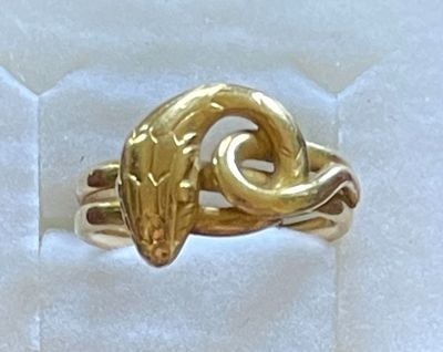 une bague en or ornée d'un serpent, dans une boîte