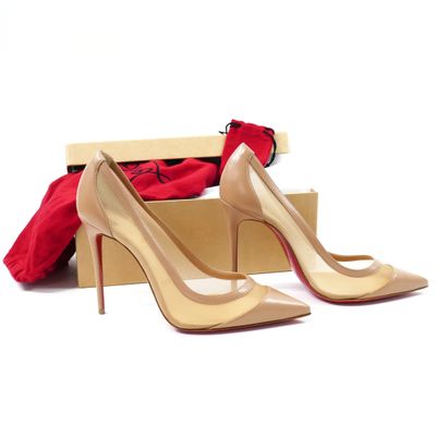 pair of women ' s nude colored high heeled shoes in a box