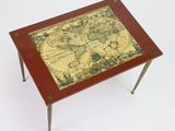 the table has a map on it and a metal legs